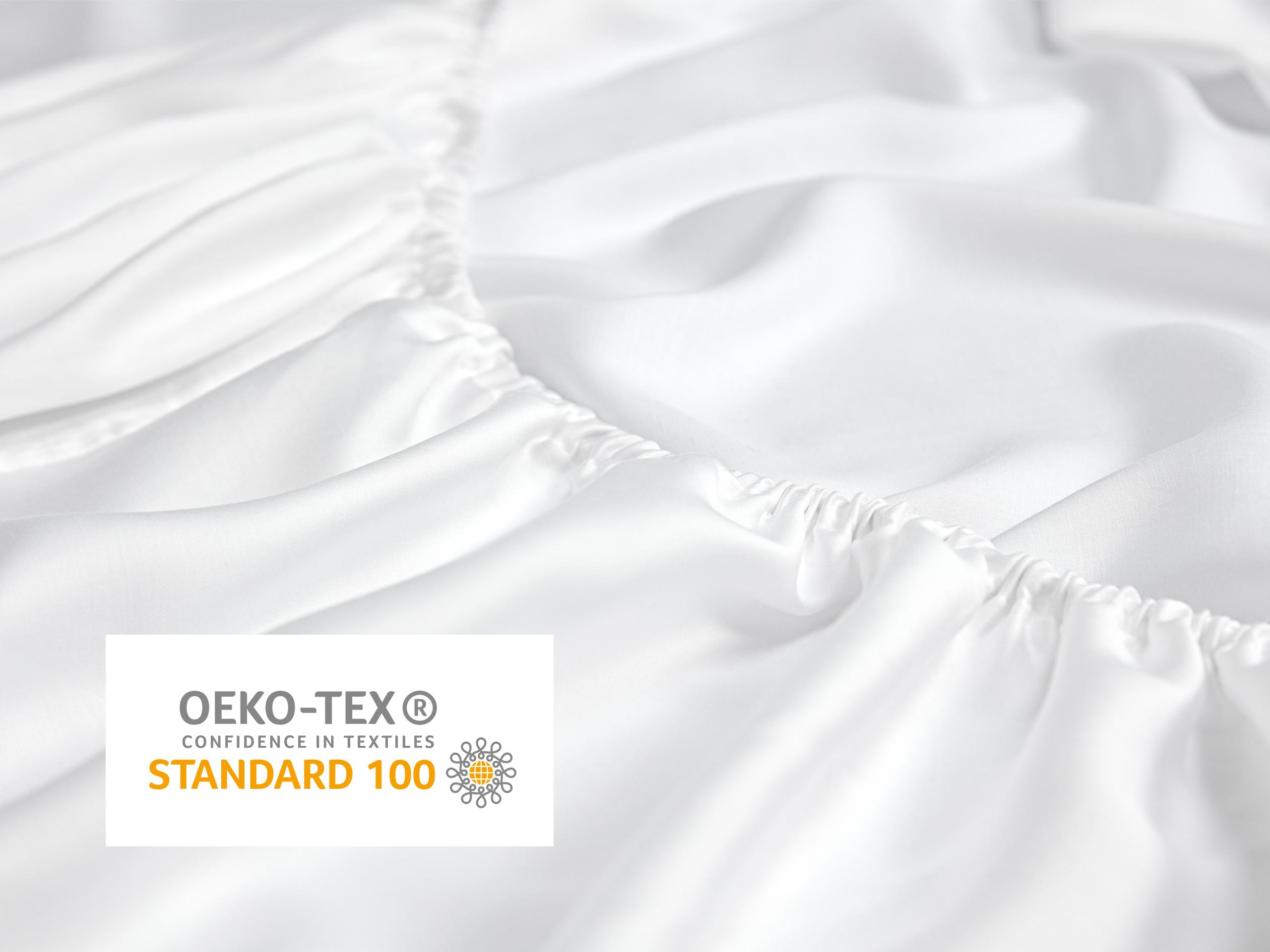 Close-up of white Sleeping Duck Fitted sheet with the text "OEKO-TEX® Confidence in Textiles Standard 100".