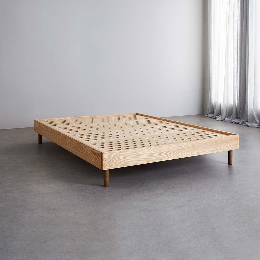 The Baker SD Indestruct Bed Base in European Ash, with standard side panels and Classic Oak Legs.
