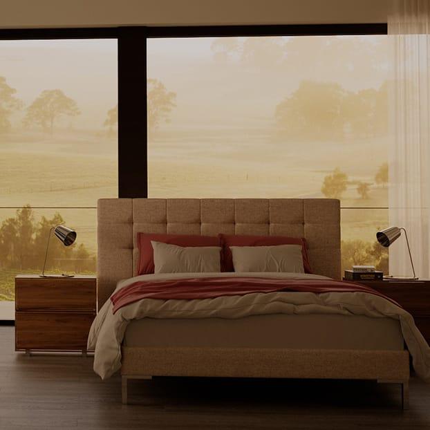 The Haussman SD Indestruct Bed in Sandstone, in a cosy postmodern bedroom overlooking a foggy countryside morning.
