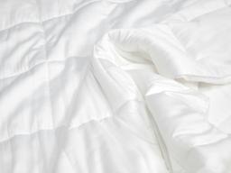 Close-up of a Sleeping Duck Duvet spread out across a bed.