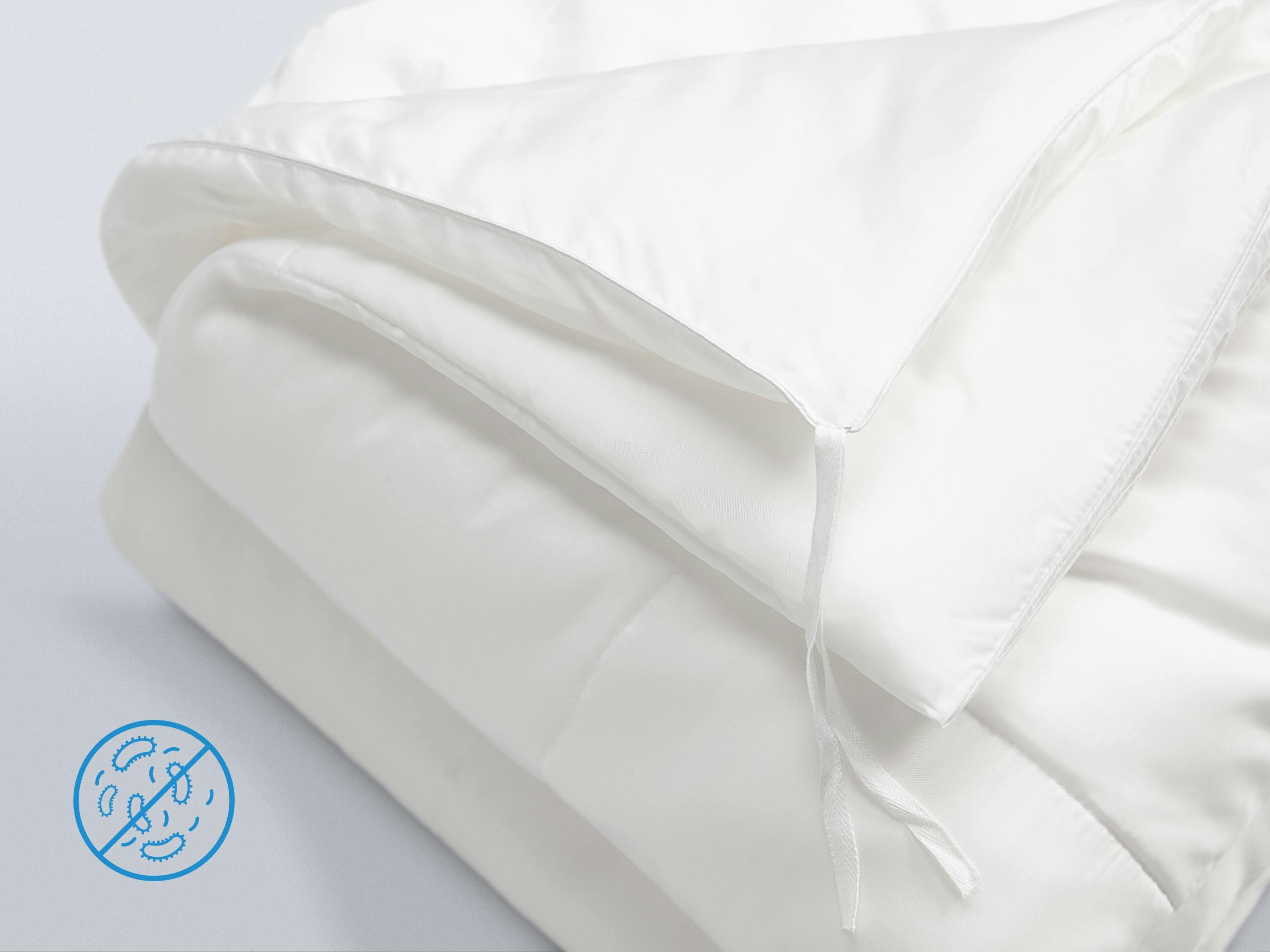 Close-up of a loosely folded Duvet with an anti-bacterial icon.