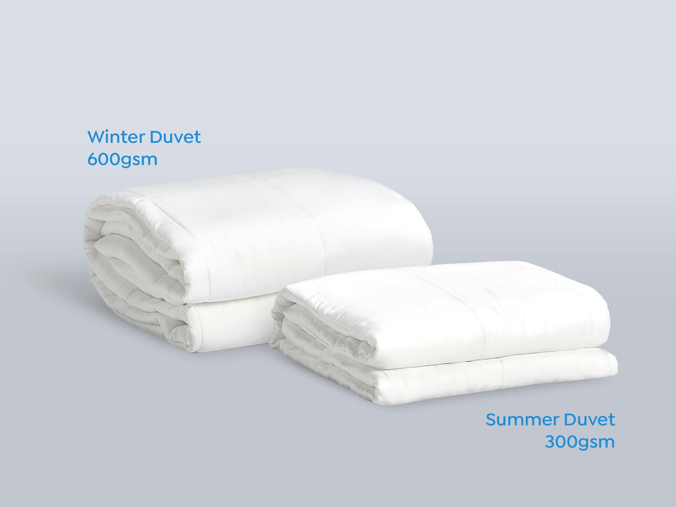 Sleeping Duck Winter Duvet and Summer Duvet neatly folded next to each other.